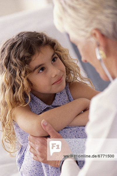 Doctor talking to young girl