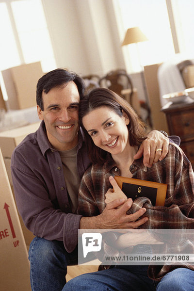 Young couple unpacking boxes in their new home