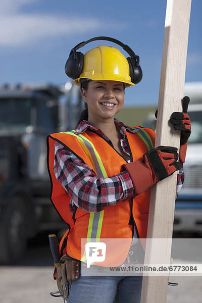Portrait of female construction worker on building site