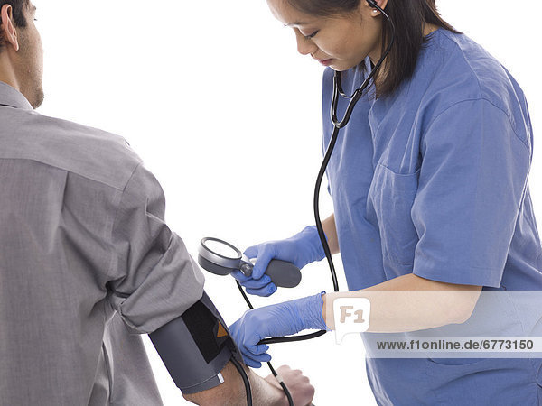 Nurse checking patients blood pressure