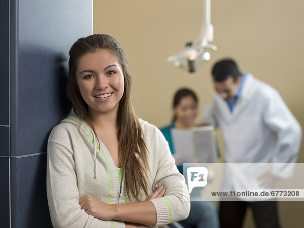 Portrait of patient  dentists in background