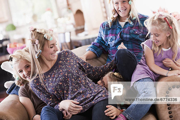 USA  Utah  family portrait of sisters (6-7  8-9  12-13  14-15  16-17) on sofa having fun