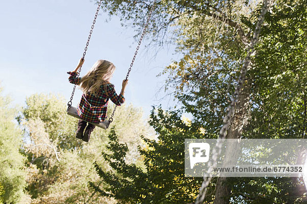 USA  Utah  girl (6-7) swinging on tree swing