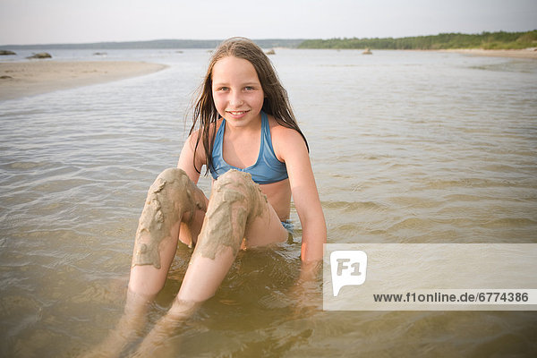 Portrait of a girl sitting in water  Grand Beach  Manitoba
