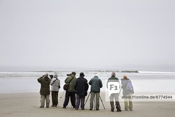 A group of bird watchers  Long Beach on Vancouver Island  near Tofino  British Columbia