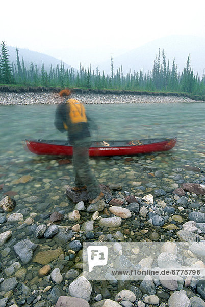 Hiker preparing his Canoe  Ogilvie River  Whitehorse  Yukon