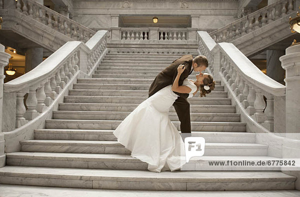 Bride and groom embracing on steps