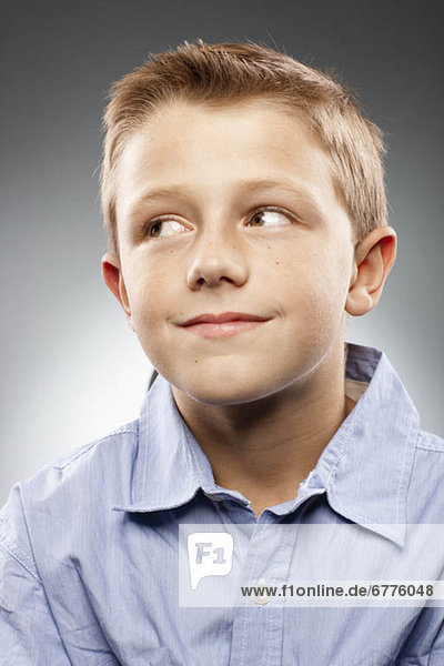 Portrait of boy (8-9) wearing shirt and looking away  studio shot
