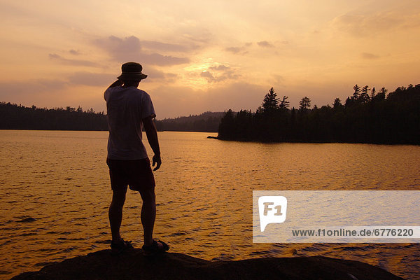 Man Standing on a Rock at Sunset  Lake Temagami  Temagami  Ontario