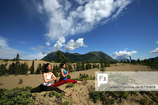 Women doing Yoga Outdoors  Carcross Desert  Yukon