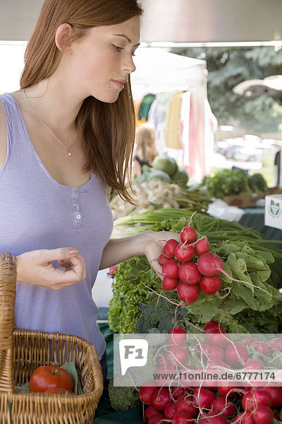 Young woman shopping at a farmer's market  Whitby  Ontario  Canada