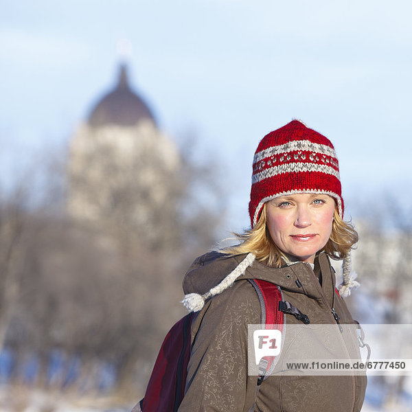 Portrait of woman dressed for ice skating on Assiniboine River Trail  Winnipeg  Manitoba