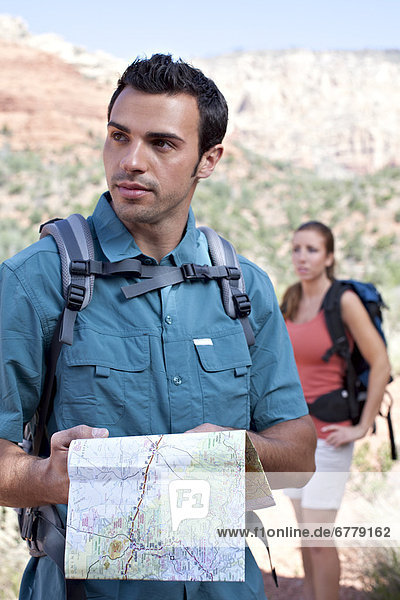 USA  Arizona  Sedona  Young couple hiking  man holding map