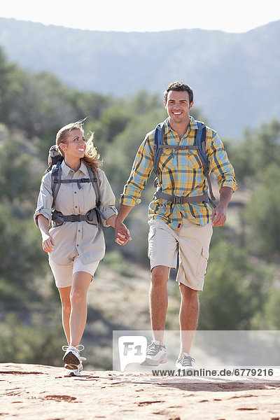 USA  Arizona  Sedona  Young couple hiking in desert