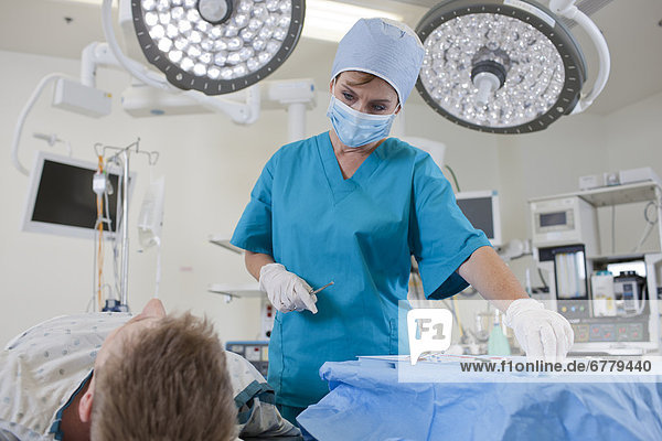 Surgeon preparing patient for surgery