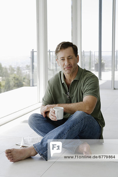Mature man relaxing with coffee cup