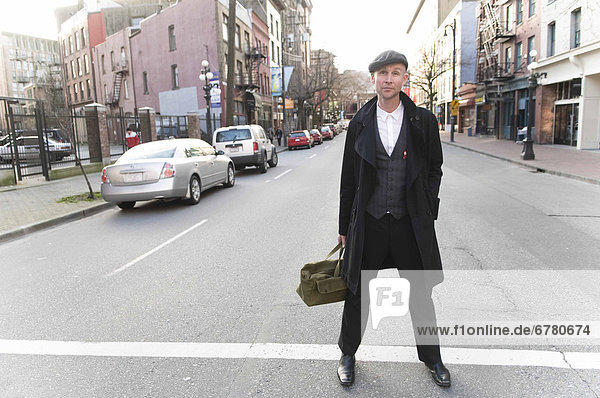 Portrait of a businessman standing in a street  Gastown  Vancouver  British Columbia