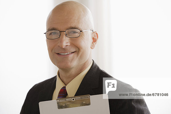 Portrait of business man holding clipboard