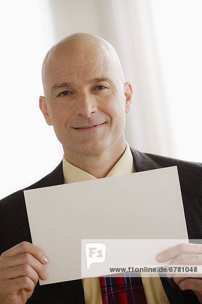 Business man holding blank paper