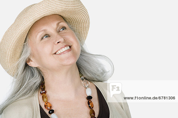 Studio portrait of mature woman wearing hat