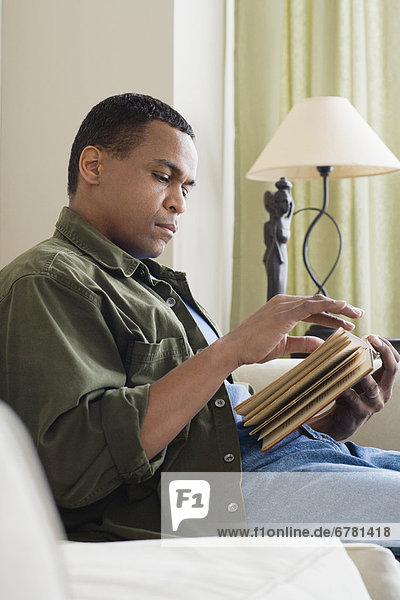 Man reading book at home