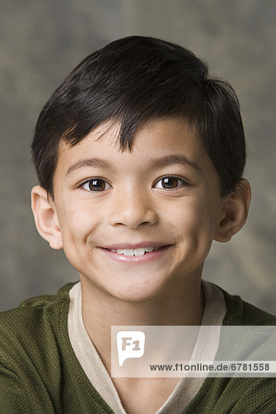 Portrait of smiling boy (8-9)  studio shot