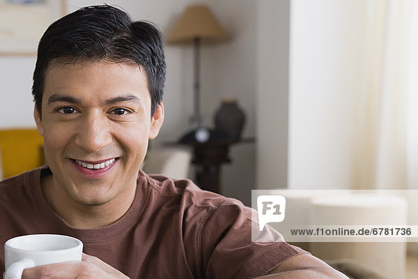Portrait of smiling man with cup