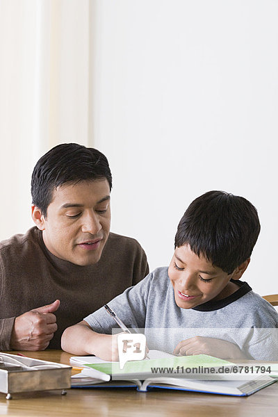 Father doing homework with son (10-11)