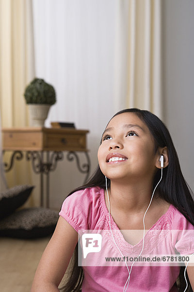 Portrait of smiling girl (8-9) with headphones