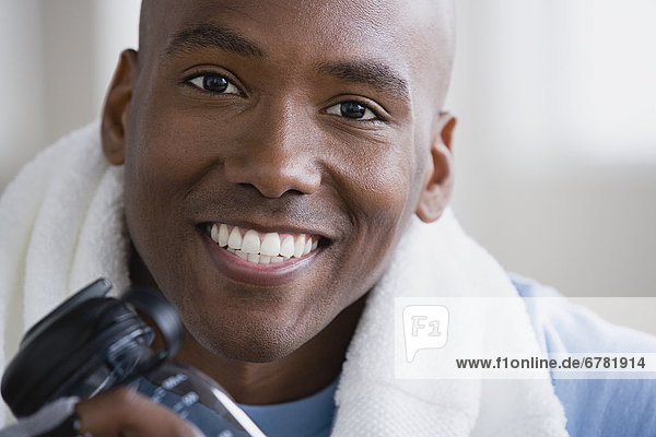 Portrait of smiling young man in gym