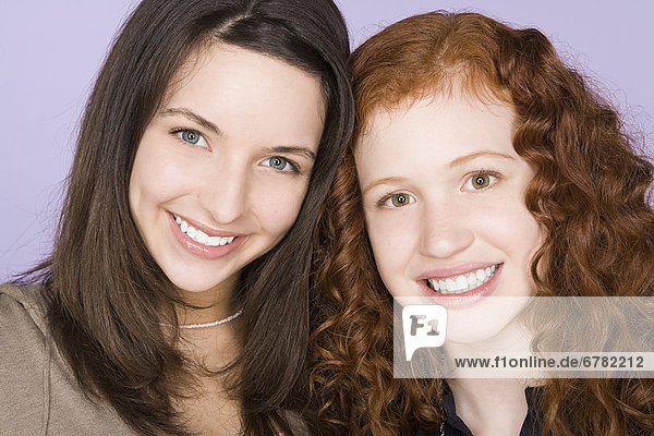 Portrait of two teenage girls (16-17) standing together