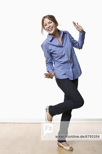Studio portrait of young woman dancing
