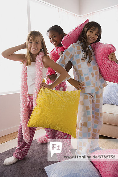 Portrait of three girls (10-11) playing at slumber party