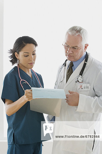 Two doctors reading document