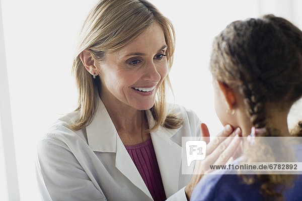 Doctor examining girl (10-11)