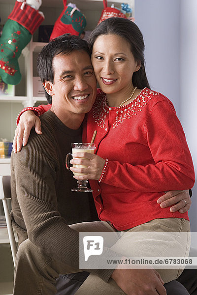 Portrait of smiling couple  Christmas stockings in background