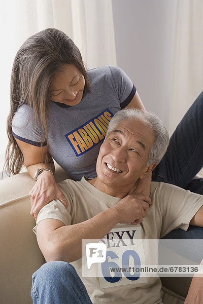Older couple holding hands and laughing