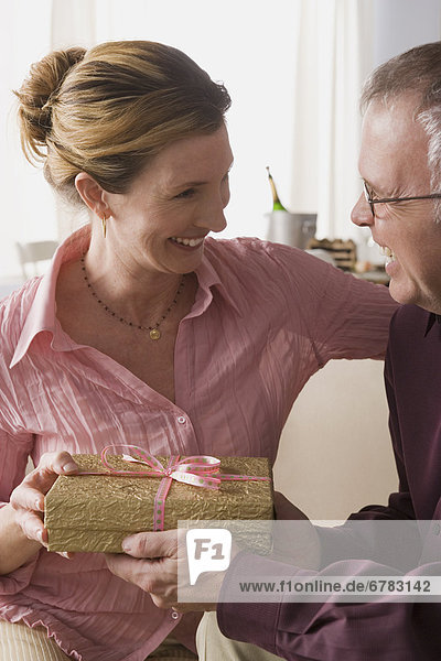 Man giving present to woman