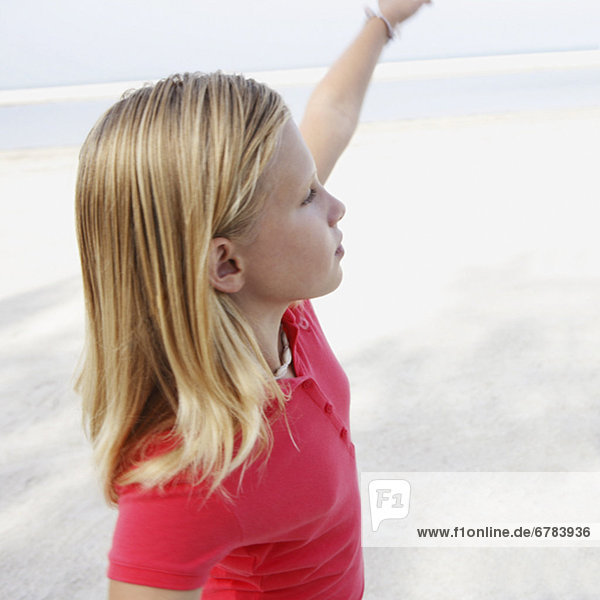 Girl on beach pointing