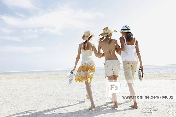 Young women walking on beach