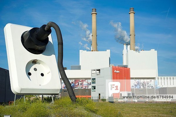 Maasvlakte Rotterdam Netherlands. Huge electrical power-outlet with plug and cable just in front of a newly build coal fired power plant.
