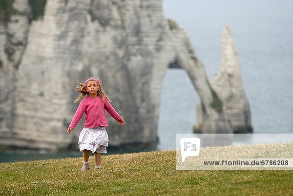 little girl dancing on the top of cliff  Etretat  Cote d´Albatre  Pays de Caux  Seine-Maritime department  Upper Normandy region  France  Europe