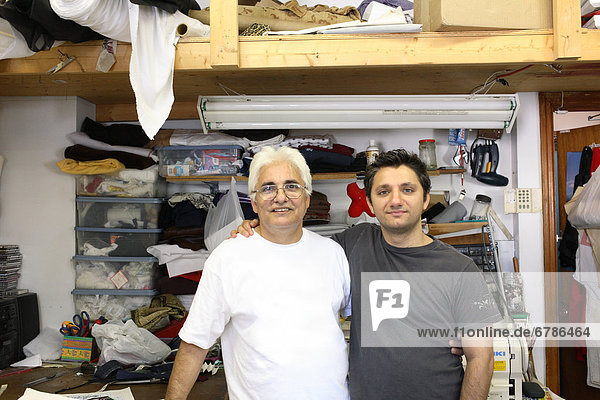 Portrait of a Father and Son in the Family Business Alteration Shop  Hamilton  Ontario
