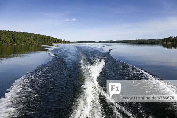 Boat wake on northern lake  Ontario