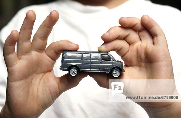 Boy Holding Toy Car in Hand