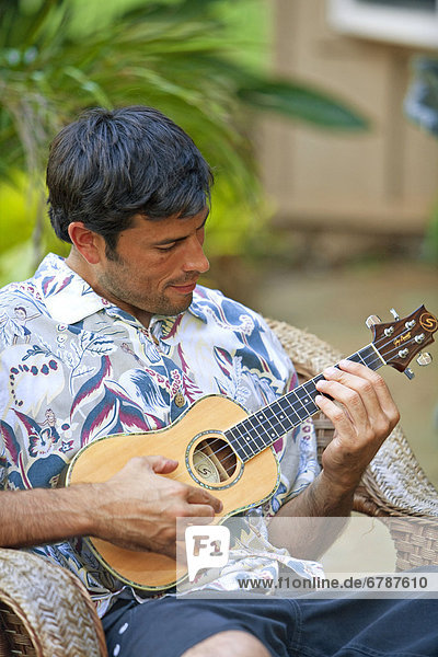 Hawaii  Maui  Local male playing an ukulele.