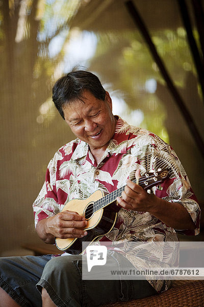 Hawaii, Maui, Local male playing an ukulele.