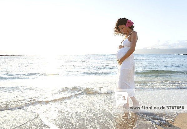 Hawaii  Pregnant woman on tropical beach.