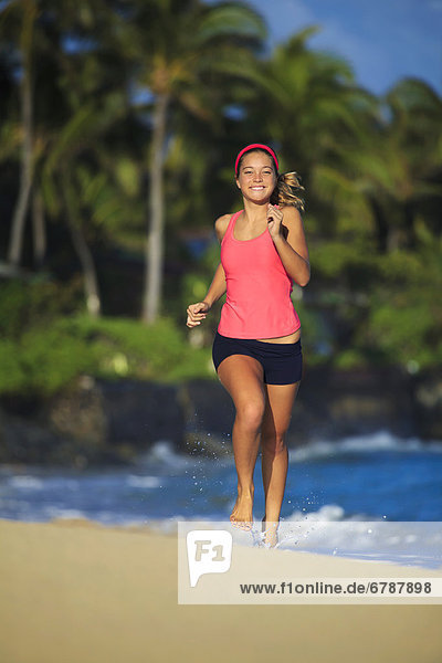 Hawaii  Oahu  Lanikai  Young woman running on beach.