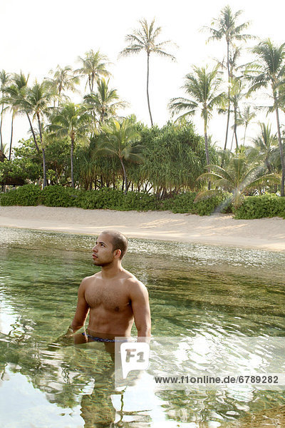 Hawaii  Oahu  Male standing in the ocean.